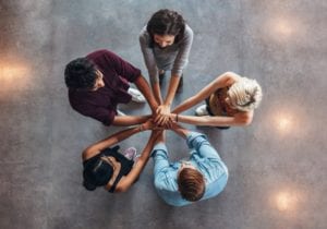 A group of people standing in the middle of a circle.